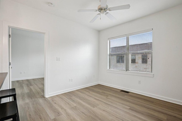 1201 Grove Blvd Unit 1502, Austin, TX 78741 - empty room with light wood-style flooring, a smoke detector, and a ceiling fan
