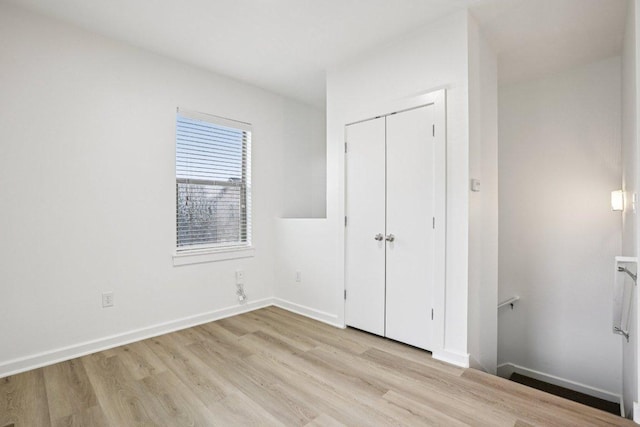 1201 Grove Blvd Unit 1502, Austin, TX 78741 - unfurnished bedroom featuring light wood-style flooring and a closet