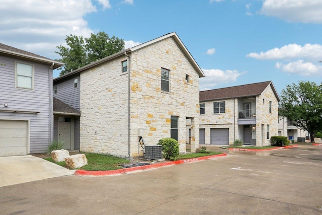 1201 Grove Blvd Unit 1502, Austin, TX 78741 - view of front of property with stone siding and a garage