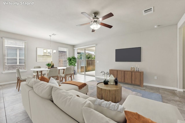 513 Heinatz Flat Ln, Leander, TX 78641 - living room with a ceiling fan, a chandelier, and light tile patterned floors