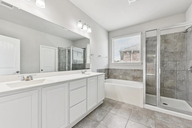 513 Heinatz Flat Ln, Leander, TX 78641 - full bathroom featuring a shower stall, double vanity, a garden tub, and tile patterned floors
