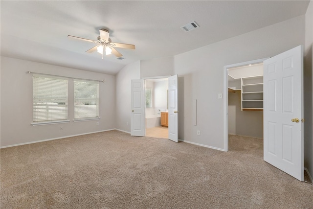 14400 Mowsbury Dr, Austin, TX 78717 - unfurnished bedroom featuring light carpet, a walk in closet, ensuite bath, a closet, and ceiling fan