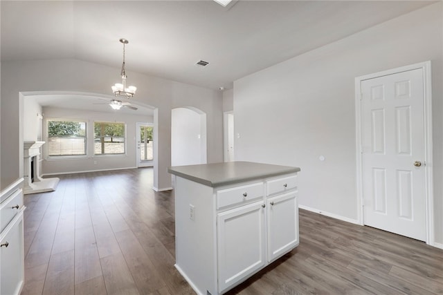 14400 Mowsbury Dr, Austin, TX 78717 - kitchen with arched walkways, dark wood-style flooring, open floor plan, a chandelier, and white cabinets