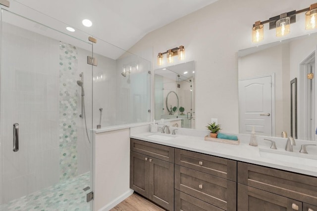 815 Clarence Bohls Ln, Pflugerville, TX 78660 - bathroom with a stall shower, double vanity, vaulted ceiling, and wood finished floors