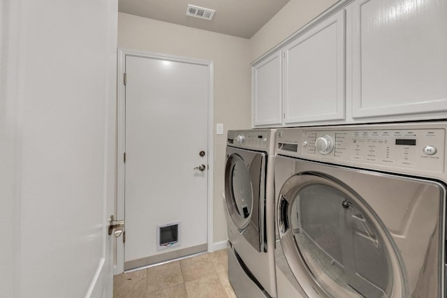 815 Clarence Bohls Ln, Pflugerville, TX 78660 - laundry room with cabinet space, washing machine and dryer, and light tile patterned flooring