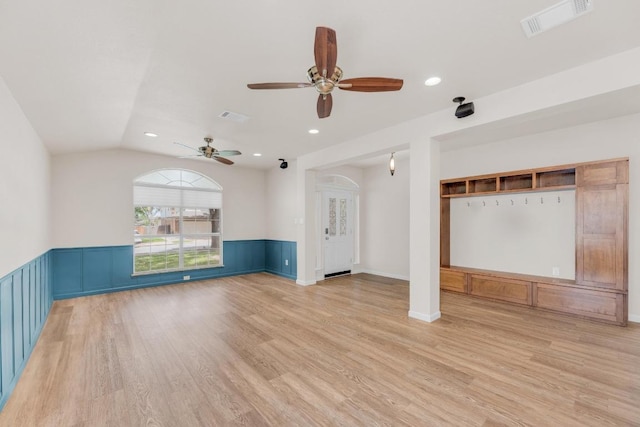 815 Clarence Bohls Ln, Pflugerville, TX 78660 - unfurnished living room with light wood-style floors, a ceiling fan, recessed lighting, a wainscoted wall, and vaulted ceiling