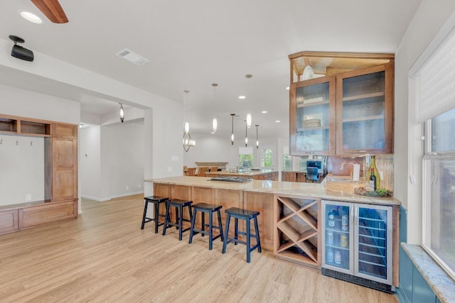 815 Clarence Bohls Ln, Pflugerville, TX 78660 - indoor wet bar with beverage cooler, light wood finished floors, decorative light fixtures, and recessed lighting