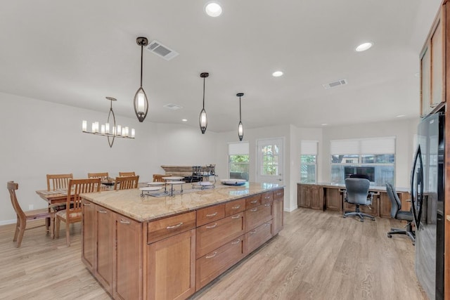 815 Clarence Bohls Ln, Pflugerville, TX 78660 - kitchen featuring freestanding refrigerator, light wood-style flooring, a desk, recessed lighting, and a kitchen island