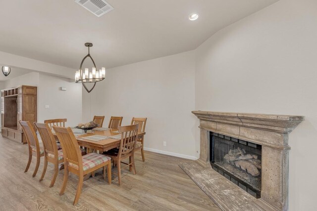 815 Clarence Bohls Ln, Pflugerville, TX 78660 - dining room with light wood finished floors, a high end fireplace, recessed lighting, and a chandelier