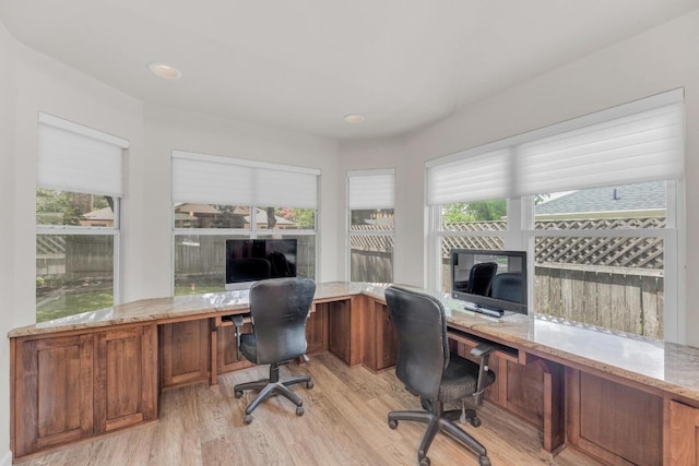 815 Clarence Bohls Ln, Pflugerville, TX 78660 - office area featuring built in study area, light wood finished floors, and healthy amount of natural light