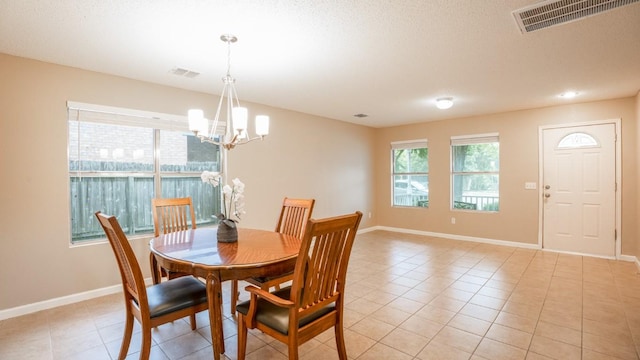 8086 Thaxton Rd, Austin, TX 78747 - dining space featuring a chandelier, light tile patterned flooring, and a textured ceiling