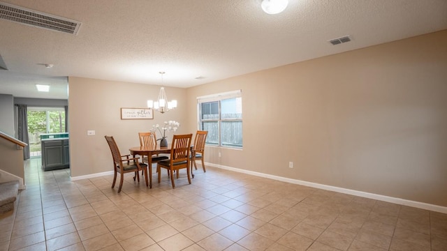 8086 Thaxton Rd, Austin, TX 78747 - dining area with a textured ceiling, a chandelier, and light tile patterned floors