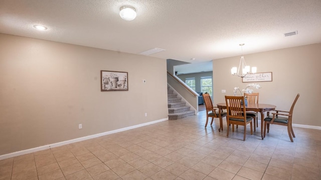 8086 Thaxton Rd, Austin, TX 78747 - dining space featuring a textured ceiling, a chandelier, light tile patterned floors, and stairs