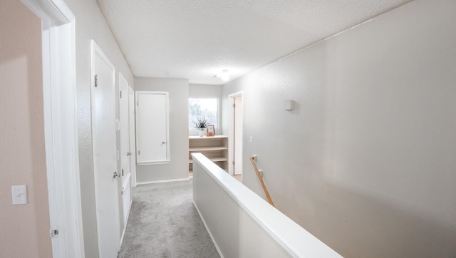 8086 Thaxton Rd, Austin, TX 78747 - hall with an upstairs landing, a textured ceiling, and light colored carpet