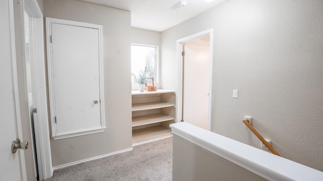 8086 Thaxton Rd, Austin, TX 78747 - hall featuring carpet, an upstairs landing, and a textured wall