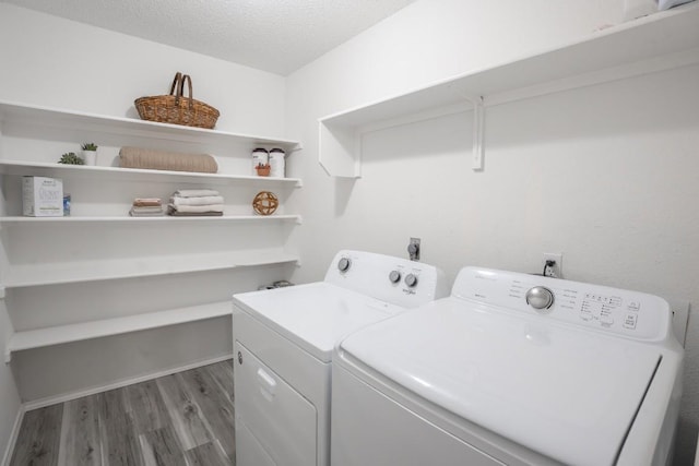8086 Thaxton Rd, Austin, TX 78747 - laundry room with washing machine and clothes dryer, light wood finished floors, and a textured ceiling