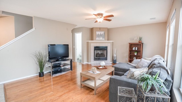 8086 Thaxton Rd, Austin, TX 78747 - living area featuring a ceiling fan, light wood-style floors, and a fireplace