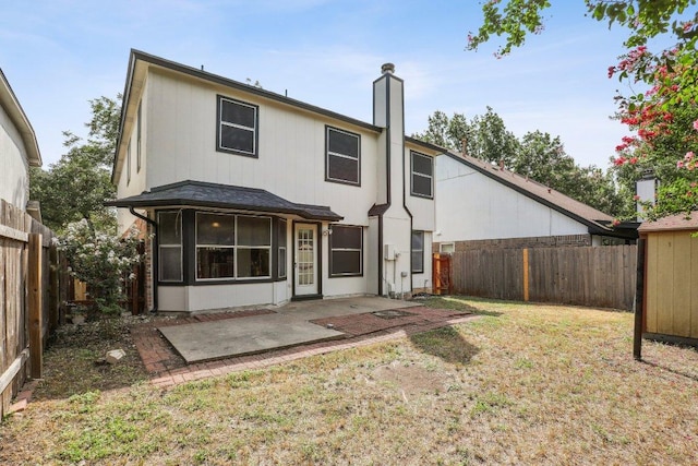 13302 Black Canyon Dr, Austin, TX 78729 - back of property featuring a chimney, a fenced backyard, and a patio