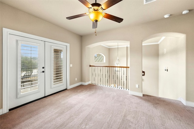 1073 Las Brisas Dr, Canyon Lake, TX 78133 - carpeted spare room featuring a ceiling fan, a smoke detector, french doors, and arched walkways