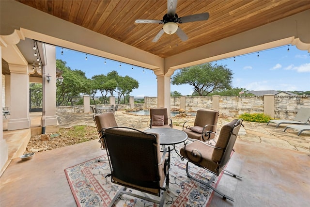 1073 Las Brisas Dr, Canyon Lake, TX 78133 - fenced backyard with a patio area, outdoor dining space, and ceiling fan