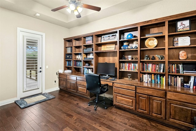 1073 Las Brisas Dr, Canyon Lake, TX 78133 - office space featuring ceiling fan, dark wood finished floors, built in study area, and a raised ceiling