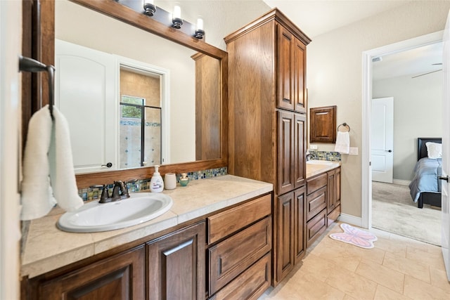 1073 Las Brisas Dr, Canyon Lake, TX 78133 - bathroom featuring double vanity, ensuite bath, and tile patterned floors