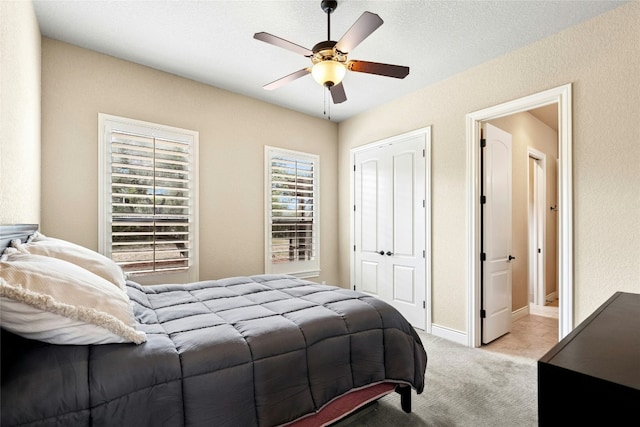 1073 Las Brisas Dr, Canyon Lake, TX 78133 - bedroom featuring light carpet, a ceiling fan, a closet, and a textured wall