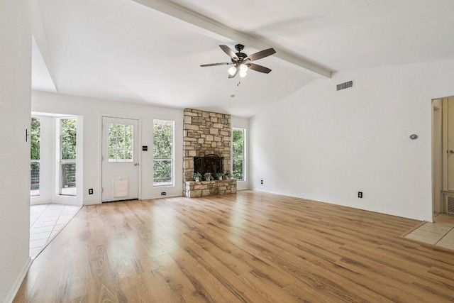1613 J J Seabrook Dr, Austin, TX 78721 - unfurnished living room with light wood finished floors, ceiling fan, and a fireplace