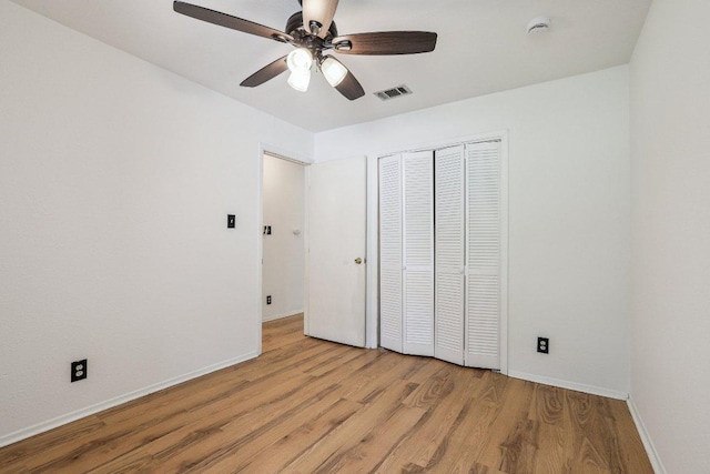 1613 J J Seabrook Dr, Austin, TX 78721 - unfurnished bedroom with light wood finished floors, a closet, and ceiling fan