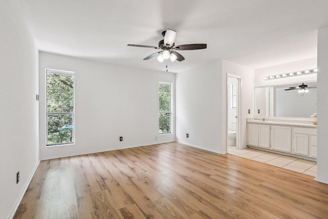 1613 J J Seabrook Dr, Austin, TX 78721 - spare room featuring plenty of natural light, light wood-style flooring, and ceiling fan
