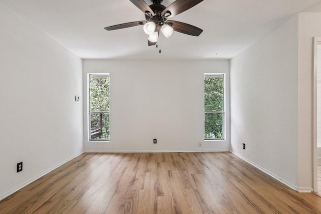 1613 J J Seabrook Dr, Austin, TX 78721 - spare room featuring wood finished floors, plenty of natural light, and ceiling fan