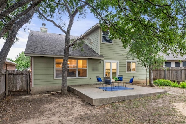 2716 Cradlerock Ter, Austin, TX 78748 - rear view of property featuring a patio area, a fenced backyard, a shingled roof, and a chimney