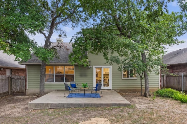 2716 Cradlerock Ter, Austin, TX 78748 - rear view of property with a fenced backyard, a patio area, roof with shingles, and a chimney