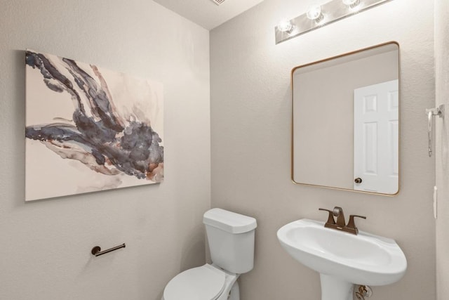 2716 Cradlerock Ter, Austin, TX 78748 - half bathroom featuring a sink and toilet