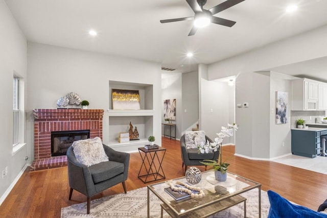 2716 Cradlerock Ter, Austin, TX 78748 - living area featuring light wood finished floors, a ceiling fan, a fireplace, and recessed lighting