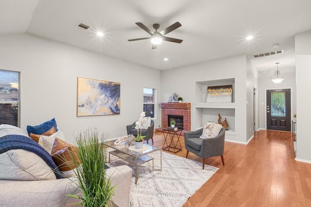 2716 Cradlerock Ter, Austin, TX 78748 - living area with built in features, wood finished floors, ceiling fan, a fireplace, and recessed lighting