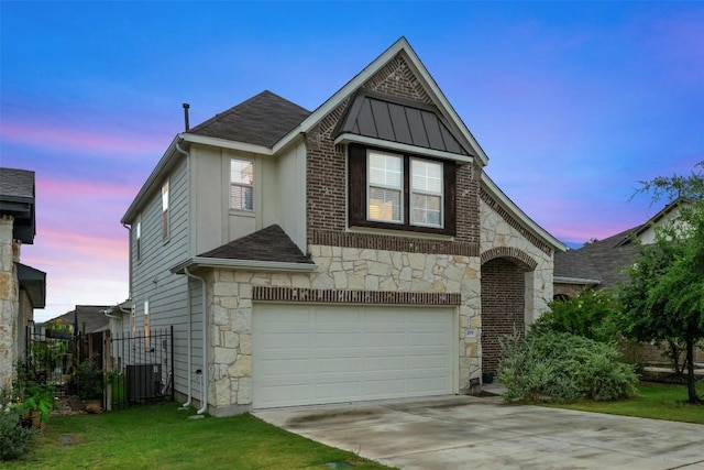 209 Lambert St, Leander, TX 78641 - view of front facade featuring stone siding, an attached garage, concrete driveway, and roof with shingles