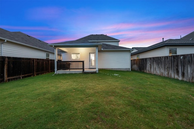209 Lambert St, Leander, TX 78641 - back of house at dusk with a fenced backyard and a shingled roof