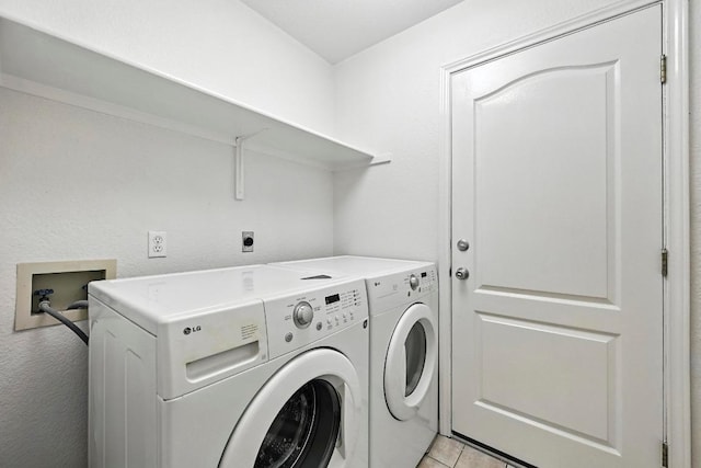 6428 Clay Allison Pass, Austin, TX 78749 - laundry area featuring washer and clothes dryer and light tile patterned flooring