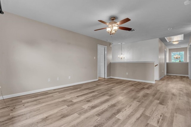 2101 Charlotte Estates Dr, Austin, TX 78744 - spare room with a chandelier, light wood-type flooring, and ceiling fan