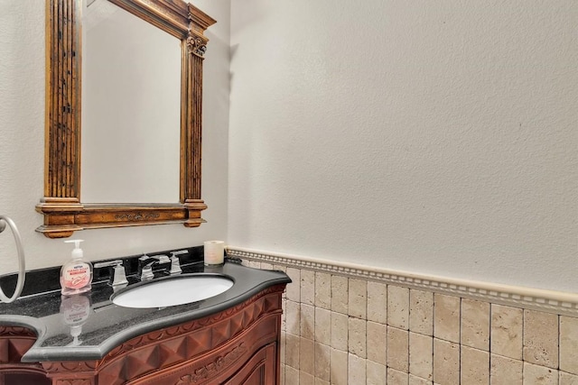 2101 Charlotte Estates Dr, Austin, TX 78744 - bathroom with vanity, a wainscoted wall, and tile walls
