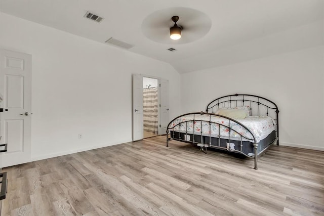 2101 Charlotte Estates Dr, Austin, TX 78744 - bedroom with wood finished floors, lofted ceiling, a ceiling fan, and ensuite bathroom