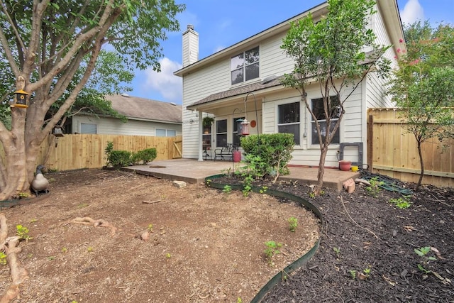 2101 Charlotte Estates Dr, Austin, TX 78744 - back of house with a patio area, a chimney, and a fenced backyard