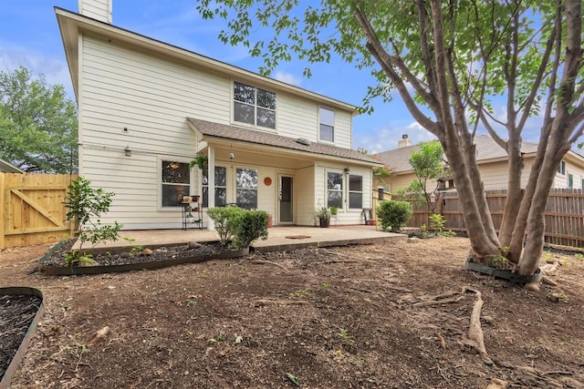 2101 Charlotte Estates Dr, Austin, TX 78744 - back of property with a patio, a chimney, and a fenced backyard