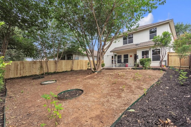 2101 Charlotte Estates Dr, Austin, TX 78744 - back of property with a fenced backyard and a patio area
