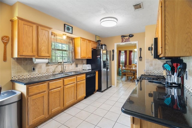 5804 Sheffield Terrace Ln, Bryan, TX 77802 - kitchen featuring dishwasher, decorative backsplash, light tile patterned floors, fridge with ice dispenser, and stainless steel microwave