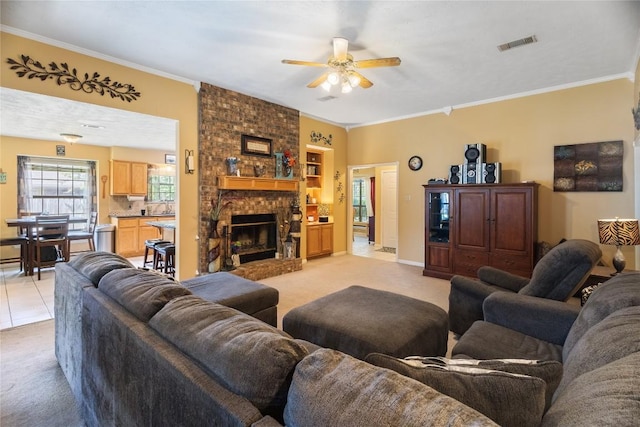 5804 Sheffield Terrace Ln, Bryan, TX 77802 - living room with light carpet, ceiling fan, crown molding, and a fireplace