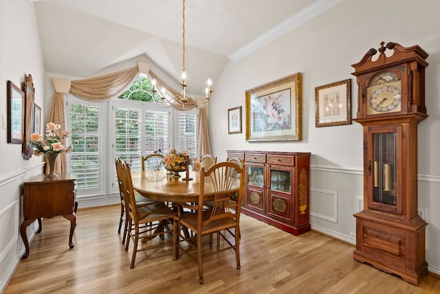 10839 Redmond Rd, Austin, TX 78739 - dining space featuring a chandelier, light wood-style floors, wainscoting, lofted ceiling, and crown molding