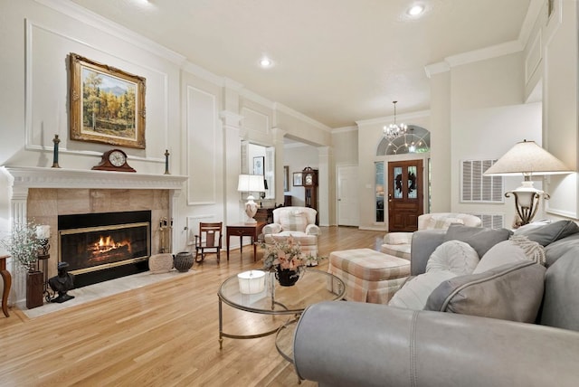 10839 Redmond Rd, Austin, TX 78739 - living room with light wood-style floors, crown molding, a fireplace, recessed lighting, and a chandelier