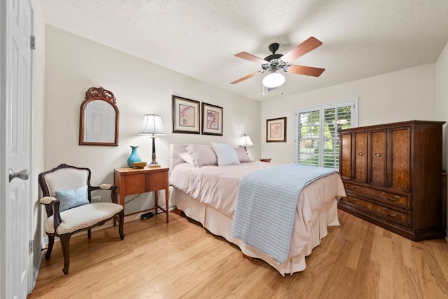 10839 Redmond Rd, Austin, TX 78739 - bedroom featuring light wood finished floors and a ceiling fan